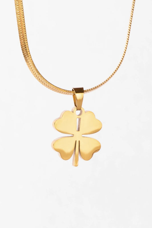 Gold necklace with a four-leaf clover pendant on a white background